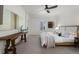Bright and airy bedroom showcasing a king-size bed, modern ceiling fan, and ample space for relaxation at 7746 E Severn Pl, Denver, CO 80230