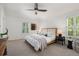 Serene bedroom featuring neutral tones, plush bedding, and ample natural light for a restful retreat at 7746 E Severn Pl, Denver, CO 80230