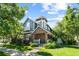 Charming two-story home featuring a turret, brick accents, balcony, and a well-manicured front yard at 7746 E Severn Pl, Denver, CO 80230