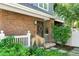 Welcoming front entrance with brick facade, decorative wreath, and lush greenery at 7746 E Severn Pl, Denver, CO 80230