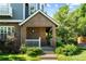 Charming brick front porch with landscaped garden, enhancing the curb appeal of this home at 7746 E Severn Pl, Denver, CO 80230