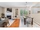 Inviting living room showcasing a fireplace, hardwood floors, and an elegant dining area at 7746 E Severn Pl, Denver, CO 80230