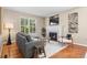 Cozy living room with a fireplace, comfortable seating, and natural light streaming through the windows at 7746 E Severn Pl, Denver, CO 80230