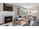Inviting living area with a fireplace, open dining space, and ample seating, perfect for gatherings at 7746 E Severn Pl, Denver, CO 80230