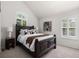 Comfortable bedroom featuring a large bed with stylish linens and abundant natural light at 7746 E Severn Pl, Denver, CO 80230