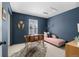 Charming office space featuring dark blue walls, unique decor, and a comfortable lounge area for creative inspiration at 7746 E Severn Pl, Denver, CO 80230