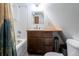 Bathroom featuring wood vanity, white tile, tub and shower at 100 Aspen Ln, Evergreen, CO 80439
