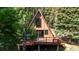 Cozy A-frame cabin with a deck nestled in a verdant, wooded area at 100 Aspen Ln, Evergreen, CO 80439