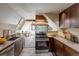 Well-lit kitchen with stainless steel appliances, granite countertops, and a breakfast nook with picturesque views at 100 Aspen Ln, Evergreen, CO 80439