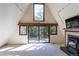 Open and airy living space featuring a fireplace and large windows overlooking a private deck at 100 Aspen Ln, Evergreen, CO 80439