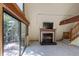 Bright living room area showcasing a fireplace and sliding glass doors that lead to the deck at 100 Aspen Ln, Evergreen, CO 80439