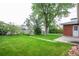 Backyard with a lush lawn and mature trees at 3222 Fenton St, Wheat Ridge, CO 80212