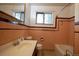 Retro bathroom with a bathtub and vanity at 3222 Fenton St, Wheat Ridge, CO 80212