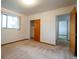 Bright bedroom with a window, neutral carpet, and closet at 3222 Fenton St, Wheat Ridge, CO 80212