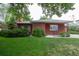 Charming single-story red brick home with a well-maintained lawn and mature landscaping at 3222 Fenton St, Wheat Ridge, CO 80212