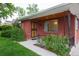 Cozy front porch of a brick home with decorative metal security door and well manicured landscaping at 3222 Fenton St, Wheat Ridge, CO 80212