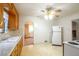 Classic kitchen with wood cabinets, tile flooring, standard appliances, and lots of natural light at 3222 Fenton St, Wheat Ridge, CO 80212