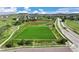 A high angle view of the baseball and soccer fields in a well-manicured suburban neighborhood with paved walking trails at 2320 Morningview Ln, Castle Rock, CO 80109