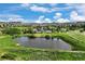 Picturesque aerial view of a pond and recreation area in the community, surrounded by lush greenery and blue skies at 2320 Morningview Ln, Castle Rock, CO 80109