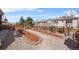 Landscaped backyard featuring stone mulch beds with mature plantings and a wood privacy fence at 2320 Morningview Ln, Castle Rock, CO 80109