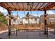 Backyard with patio featuring an overhead pergola with string lights and garden accents at 2320 Morningview Ln, Castle Rock, CO 80109