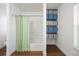 Well-lit bathroom with a shower and built in shelving for optimal storage at 2320 Morningview Ln, Castle Rock, CO 80109