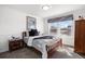 Cozy bedroom featuring a queen bed, side table, and large window for ample natural light at 2320 Morningview Ln, Castle Rock, CO 80109