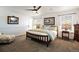 Bright bedroom featuring a ceiling fan, picture window, and a comfortable bed for restful nights at 2320 Morningview Ln, Castle Rock, CO 80109