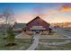 Exterior shot of The Grange at The Meadows community center with picturesque landscaping and sunset at 2320 Morningview Ln, Castle Rock, CO 80109
