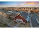 Aerial view of The Grange at The Meadows showcasing a community center, lake, and sunset at 2320 Morningview Ln, Castle Rock, CO 80109