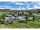 Aerial view of the community pool area featuring multiple pools, a waterslide, and a clubhouse on a sunny day at 2320 Morningview Ln, Castle Rock, CO 80109