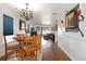 Cozy dining area with hardwood floors and an ornate chandelier, perfect for Gathering meals and entertaining guests at 2320 Morningview Ln, Castle Rock, CO 80109