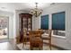 Dining area with a round table, china cabinet, and natural light from the window at 2320 Morningview Ln, Castle Rock, CO 80109