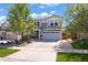 Charming two-story home featuring a well-manicured lawn, flower beds and an attached two-car garage at 2320 Morningview Ln, Castle Rock, CO 80109