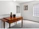 Upstairs hallway featuring carpet, wooden accent table, neutral colors, and a brightly lit window at 2320 Morningview Ln, Castle Rock, CO 80109