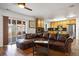 Living room featuring hardwood floors, a large leather sofa, and sliding door to the backyard at 2320 Morningview Ln, Castle Rock, CO 80109