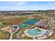 Community aerial view featuring a pool, tennis courts, playground, and extensive walking trails and green spaces at 14341 Beebalm Loop, Parker, CO 80134