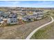 An aerial shot shows a neighborhood with walking paths, modern homes with landscaping and thoughtful designs at 14341 Beebalm Loop, Parker, CO 80134