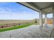 The covered back patio provides great views and features a stone patio, artificial turf, and a modern design at 14341 Beebalm Loop, Parker, CO 80134