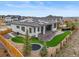 Modern home featuring a backyard with solar panels, a patio, a trampoline, and professional landscaping at 14341 Beebalm Loop, Parker, CO 80134