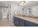 Bathroom vanity with navy cabinets, quartz countertop, and modern fixtures at 14341 Beebalm Loop, Parker, CO 80134