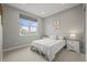 Bright bedroom with neutral walls, carpet, and a large window offering neighborhood views at 14341 Beebalm Loop, Parker, CO 80134