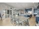 Open concept dining and kitchen area featuring a large dining table and hardwood floors at 14341 Beebalm Loop, Parker, CO 80134