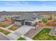 Modern home with a three-car garage, stone accents, landscaped yard, and backyard trampoline at 14341 Beebalm Loop, Parker, CO 80134