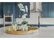 Close-up of a modern kitchen island with decorative accents including flowers, candles, and a statue at 14341 Beebalm Loop, Parker, CO 80134