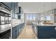 Bright, modern kitchen with white countertops, navy cabinets, and a spacious layout at 14341 Beebalm Loop, Parker, CO 80134