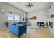 Bright living room with large windows, hardwood flooring, modern furniture, and a fireplace at 14341 Beebalm Loop, Parker, CO 80134