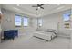 Spacious main bedroom featuring a tray ceiling, large windows, a sitting area, and neutral decor at 14341 Beebalm Loop, Parker, CO 80134