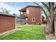 Grassy backyard with a detached shed, patio, and balcony overlooking the backyard at 2927 N Humboldt St, Denver, CO 80205