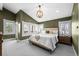 Bright bedroom featuring large windows, neutral carpet, vaulted ceilings, and stylish lighting at 2927 N Humboldt St, Denver, CO 80205